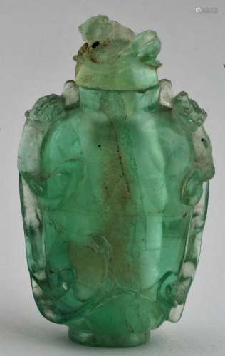 Green quartz snuff bottle. China. 19th century. Surface carved with chih lung. Damage to stopper. 2-3/4
