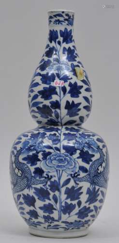 Porcelain vase. China. 19th century. Double gourd form. Underglaze blue decoration of dragons and flowers. 4 character Ch'ien Lung mark on the base. 12