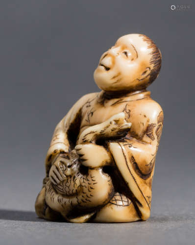 AN IVORY NETSUKE OF A MAN WITH A GOOSE