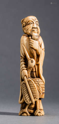 A STAG ANTLER NETSUKE OF A CHINESE SAGE WITH CRANE