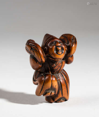 A WOODEN NETSUKE OF A SANBASO DANCER