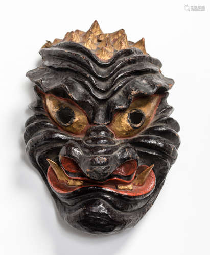 A PAPER MACHE MASK OF AN ONI