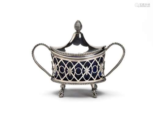 A silver mustard pot with blue glass liner