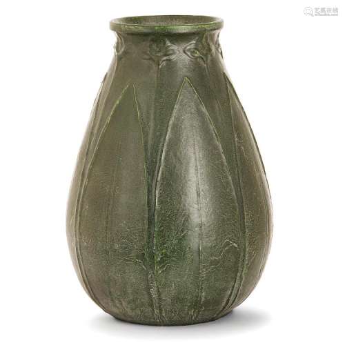 GRUEBY Vase ovoïde en faïence, décor en bas-relief de hautes feuilles rythmées de hampes florales, émail vert légèrement réticulé....