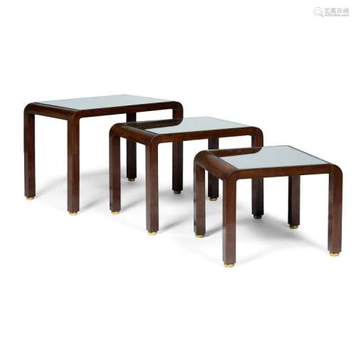 JULES LELEU (1883-1961) Suite de trois tables gigognes en acajou, piétement quadripode, sabots en métal doré, plateaux formés de d...