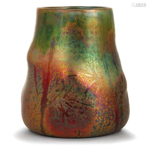 CLÉMENT MASSIER (1844-1917) Vase tronconique en faïence, corps animé de ressauts galbés, décor végétal de bambous, émaux rouges, v...