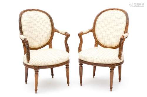 A pair of nutwooden Louis XVI armchairs