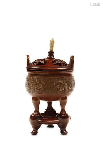 A BRONZE INCENSE BURNER. Qing Dynasty. On tripod f