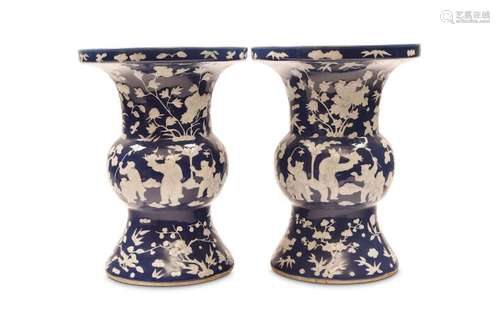 A PAIR OF SLIP-DECORATED BLUE GROUND VASES. GU. Qi