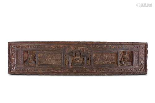 A WOOD BOOK COVER. Carved to depict a central deit