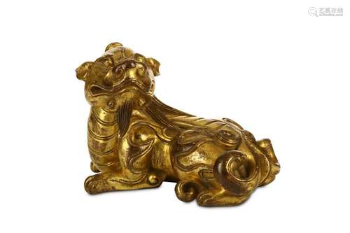 A GILT BRONZE DOG SCROLL WEIGHT. 8.5cm long, 552g.