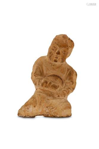 A POTTERY MODEL OF A BOY. Tang Dynasty. Seated wit