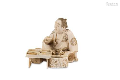 AN IVORY OKIMONO OF A MAN EATING. Meiji Period. Se