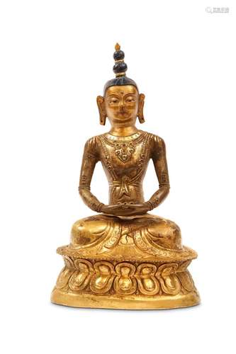 A GILT METAL REPOUSSE SEATED BUDDHA. Qing Dynasty,