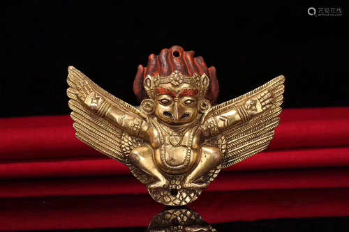 A TIBETAN GILT BRONZE ROC AMULET