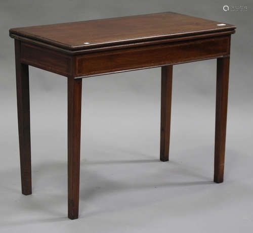 A George III mahogany fold-over tea table with satinwood crossbanded decoration