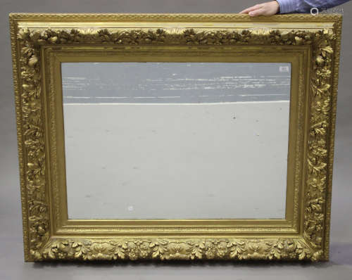 A 19th century gilt moulded composition rectangular wall mirror with leaf scroll decoration