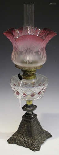 A late 19th century cut glass and patinated cast metal table oil lamp