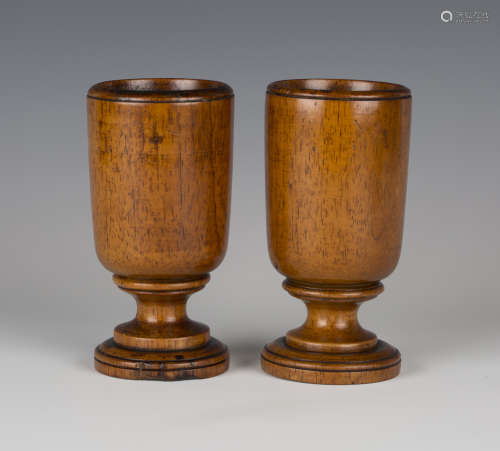 A pair of 19th century turned beech goblet cups of mid-brown colour