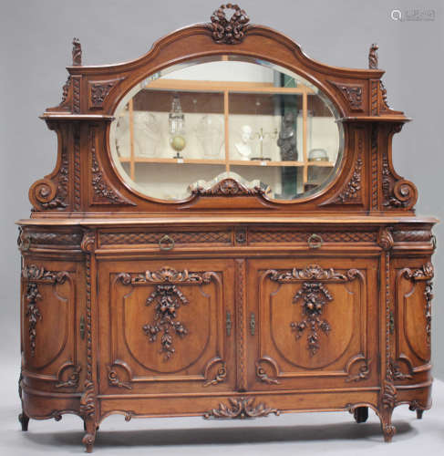 A late 19th century French walnut side cabinet with carved decoration