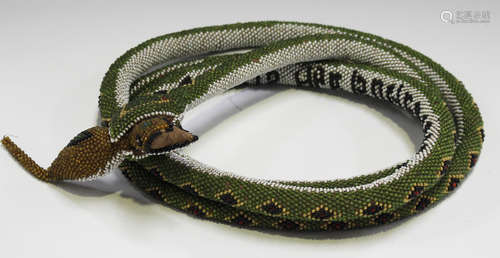 An early 20th century Turkish prisoner-of-war beadwork model of a snake with a lizard in its mouth