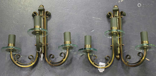 A pair of mid-20th century French gilt and green painted cast bronze three light wall sconces with circular glass mounts