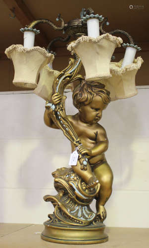 A 20th century gilt painted cast composition table light in the form of a putto supporting five scroll branches
