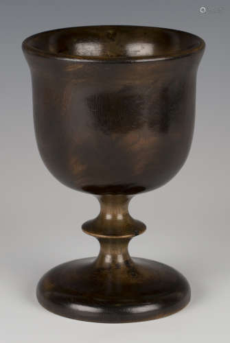 A 19th century turned fruitwood goblet of generous proportions with a rich dark patina