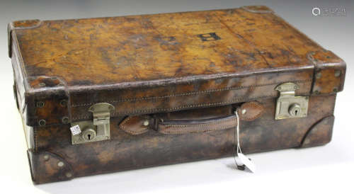 An early 20th century brown leather suitcase