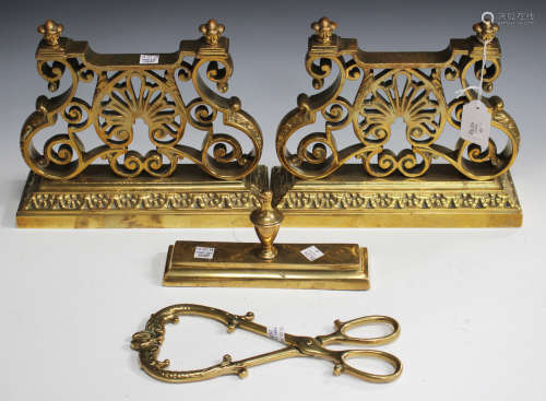A pair of late 19th century gilt brass fire tool rests of palmette and scroll design