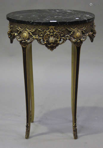A modern gilt painted and black marble topped oval side table with shell and scroll decoration