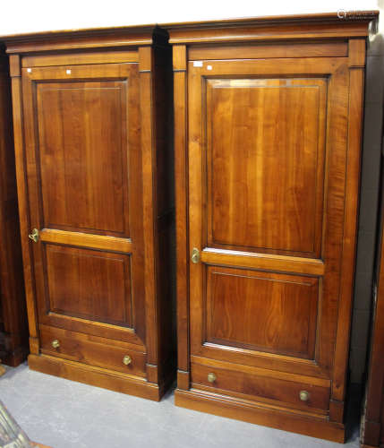 A pair of modern cherrywood single door wardrobes