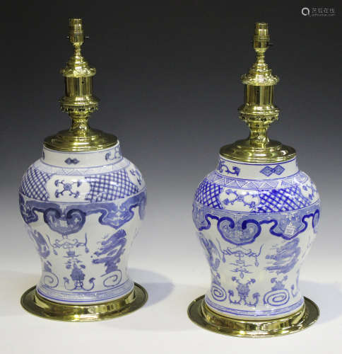 A pair of Chinese blue and white porcelain and brass mounted table lamps of baluster form