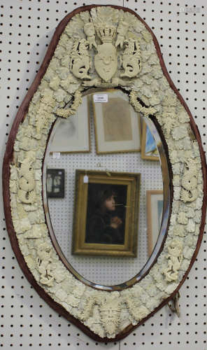 A 19th century Dieppe ivory and bone oval wall mirror