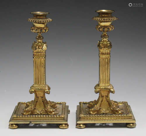 A pair of mid-19th century gilded cast bronze candlesticks