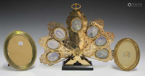 An unusual late 19th century engraved brass miniature photograph holder in the form of a fan shaped fire screen