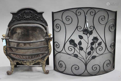 An early 20th century cast iron and brass mounted fire basket with spiral reeded finials and leaf mounts