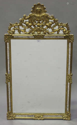 A late 20th century gilt framed sectional wall mirror with shell surmount and scroll decoration