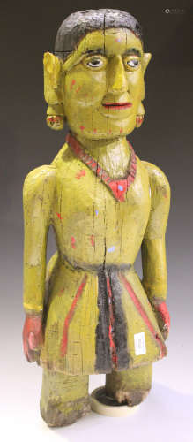 An Indian carved wooden figure with later painted decoration