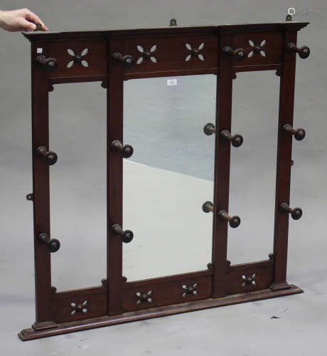 A late Victorian mahogany hanging coat rack with a central mirror panel