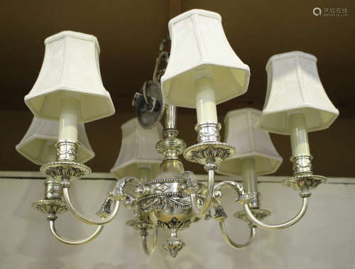 A pair of 20th century plated cast metal six light chandeliers of neoclassical design