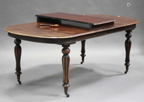 A 20th century William IV style mahogany extending dining table with a single extra leaf