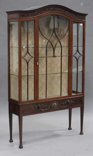 An early 20th century mahogany display cabinet with carved decoration