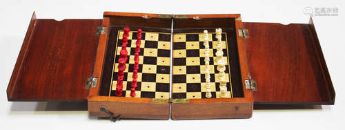 An Edwardian mahogany cased travelling chess set