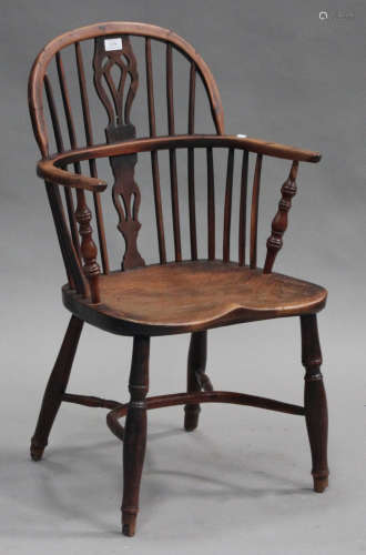 A mid-19th century yew and elm pierced splat back Windsor armchair
