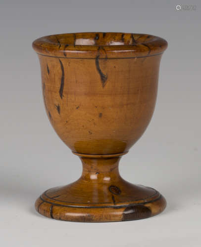 An early/mid-19th century turned fruitwood egg cup with distinctive figuring