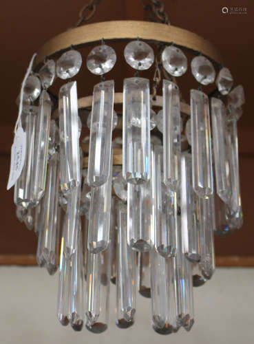 An early 20th century gilt metal and cut glass three-tier ceiling light