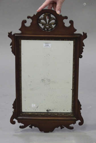 A late 19th century mahogany fretwork framed wall mirror with gilded and pierced surmount