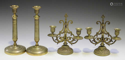 A pair of Regency gilt bronze candlesticks decorated with overall bands of flowerheads