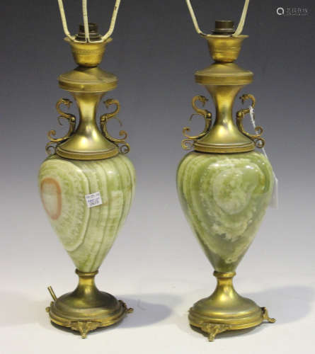 A pair of early 20th century onyx and gilt metal mounted table lamps